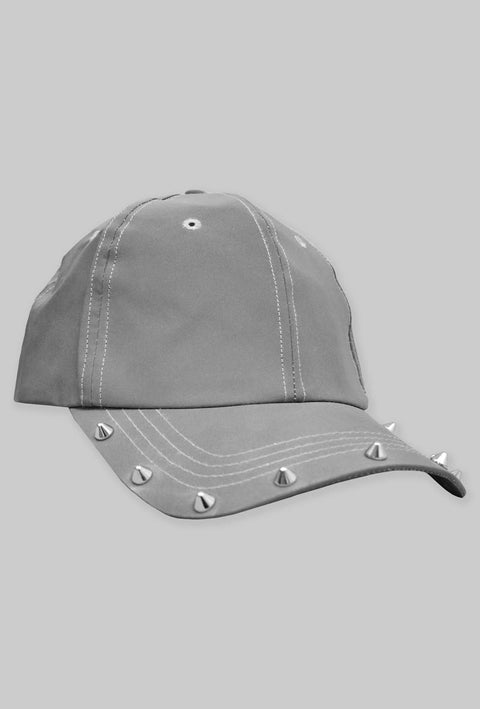  cappellino unisex grigio in stoffa catarifrangente con cuciture bianche e borchie argentate lungo il bordo della visiera